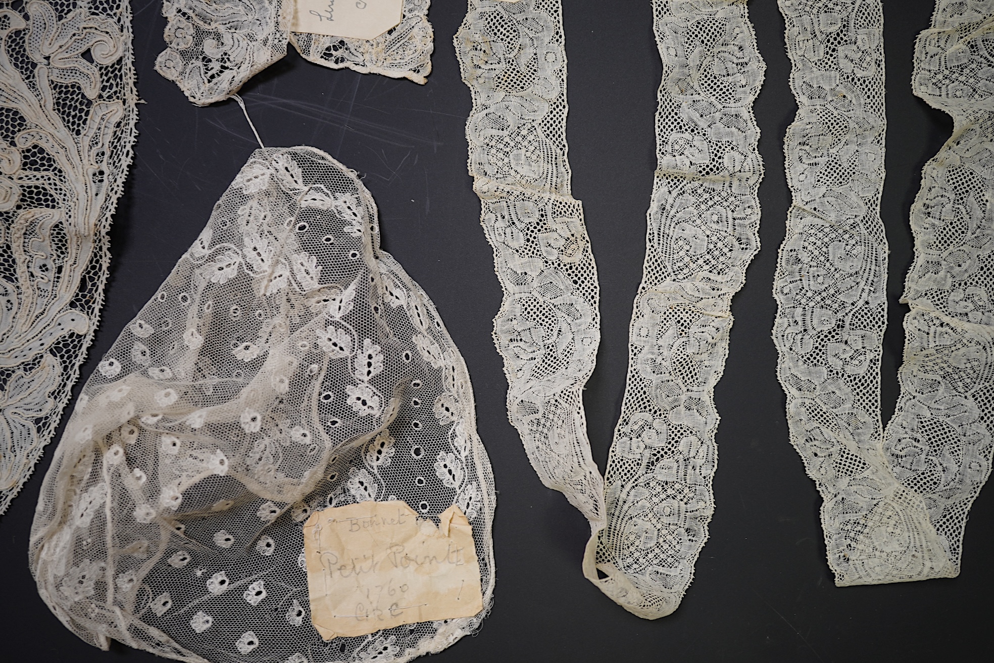 Various lengths of 18th and 19th century lace trimming and two needle run bonnets. Including a collar made from two rows of 18th century Valenciennes lace, a length Valenciennes lace, a shorter length of Pointe de Anglet